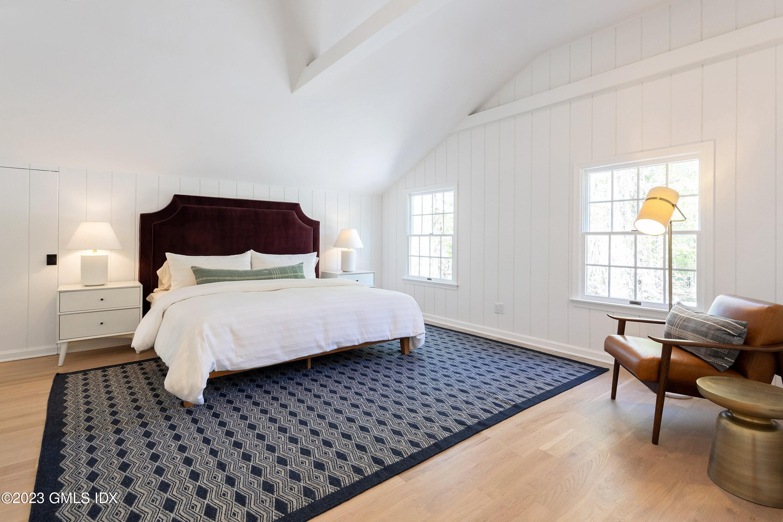 48 Old Mill Road Greenwich, CT 06831 - Photo 27 of 47 a bedroom with a bed and wooden floor