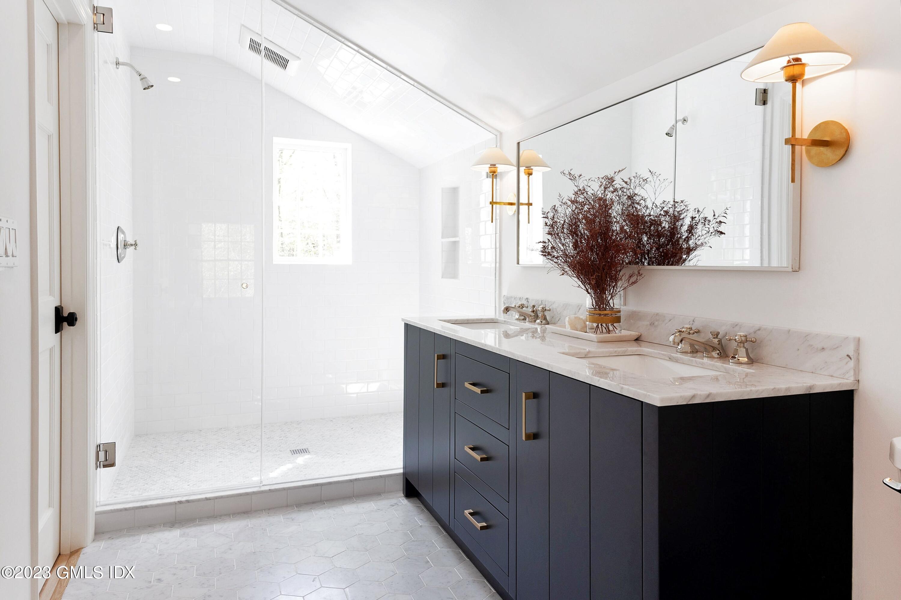 48 Old Mill Road Greenwich, CT 06831 - Photo 28 of 47 a bathroom with a shower sink and mirror