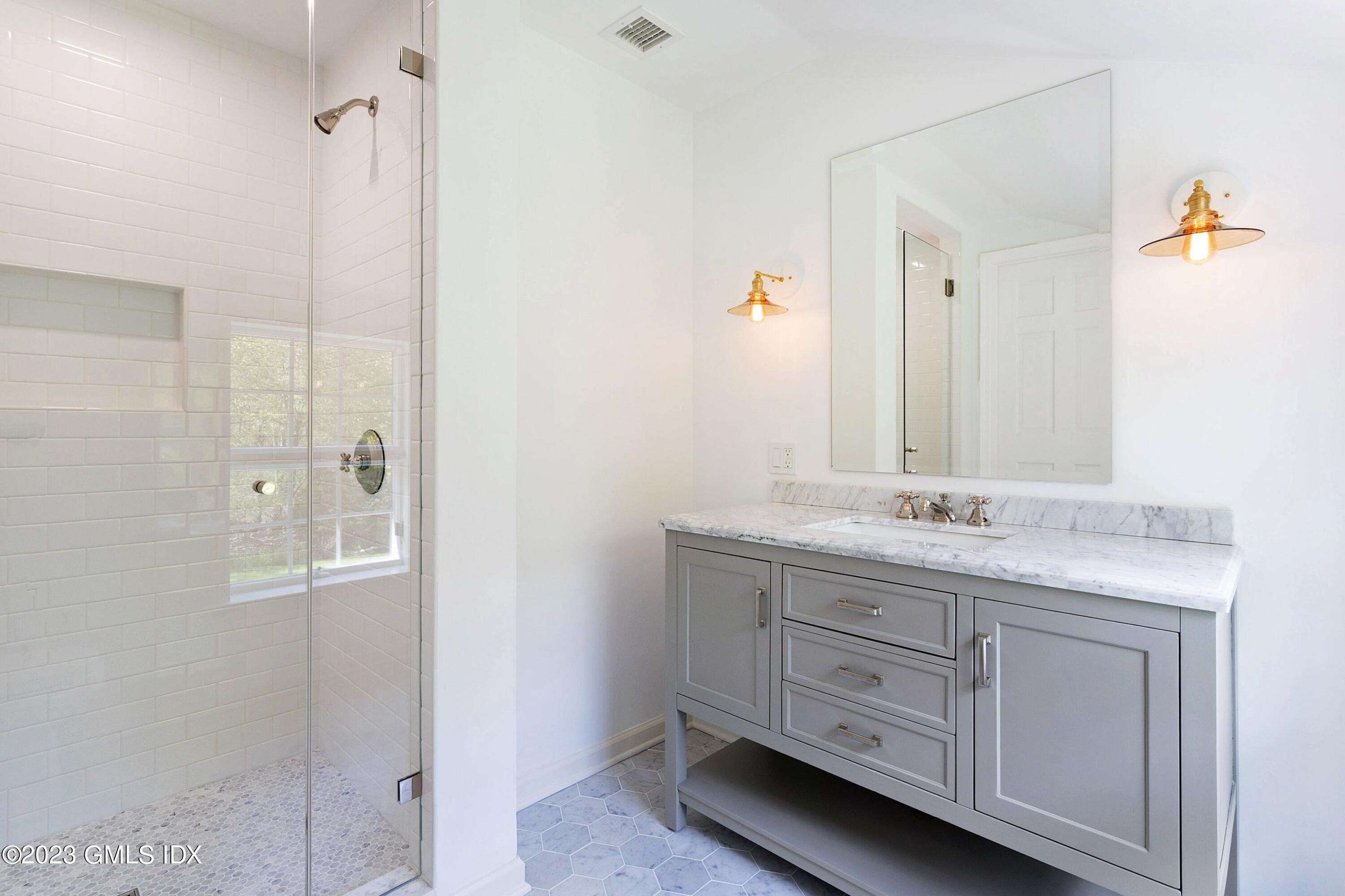 48 Old Mill Road Greenwich, CT 06831 - Photo 33 of 47 a bathroom with a granite countertop sink and a mirror