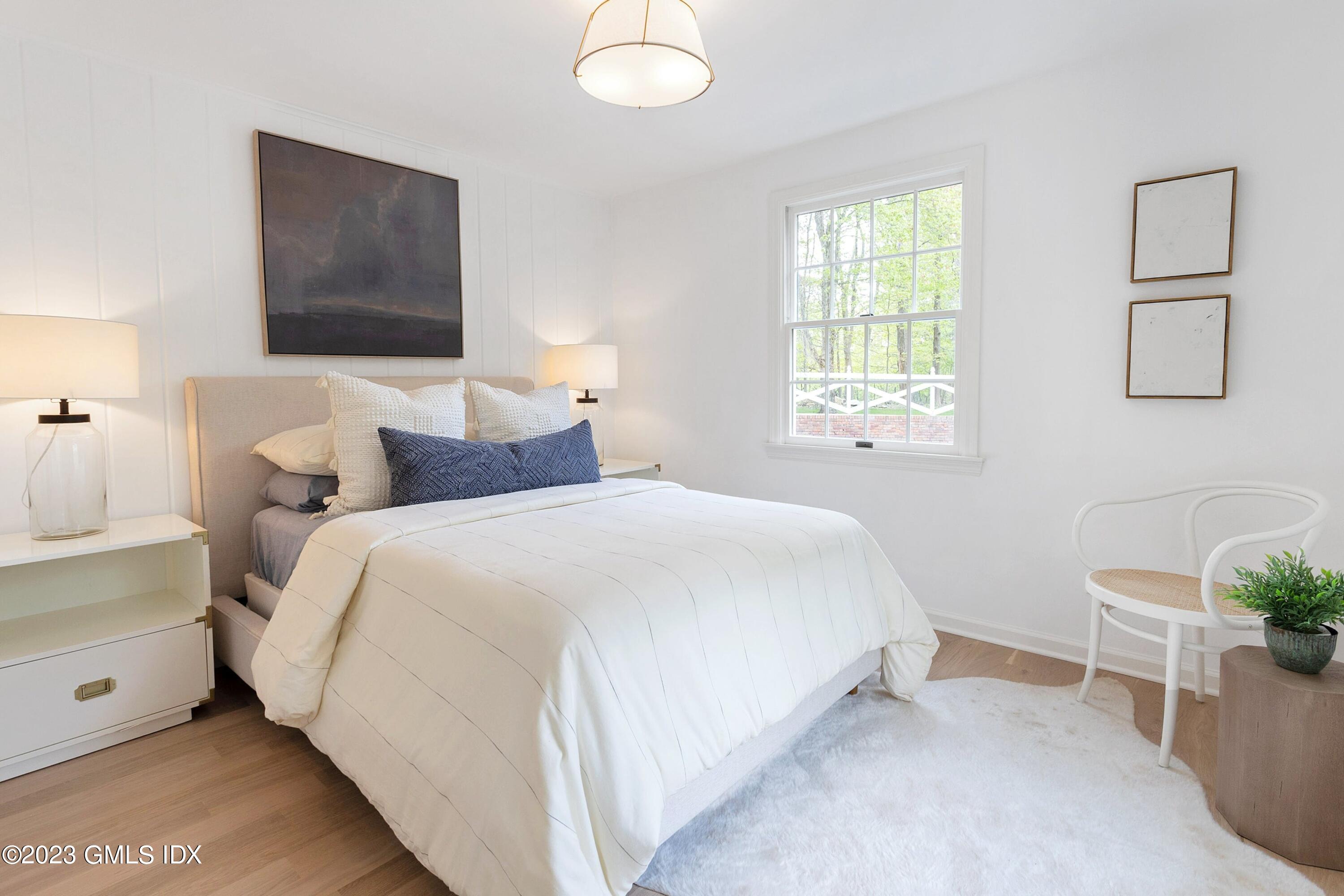 48 Old Mill Road Greenwich, CT 06831 - Photo 34 of 47 a bedroom with a bed and a lamp