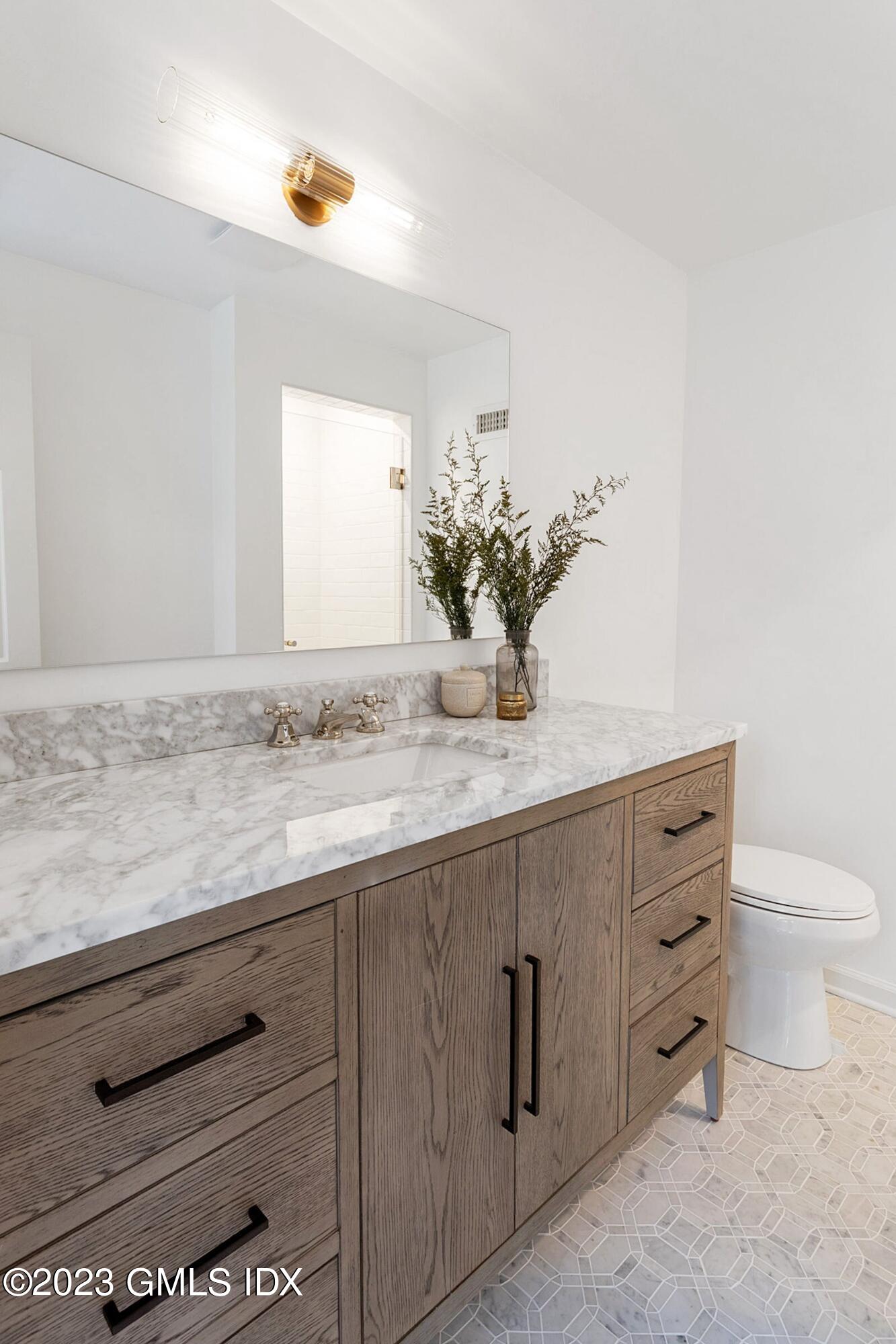 48 Old Mill Road Greenwich, CT 06831 - Photo 35 of 47 a bathroom with a granite countertop sink and a mirror