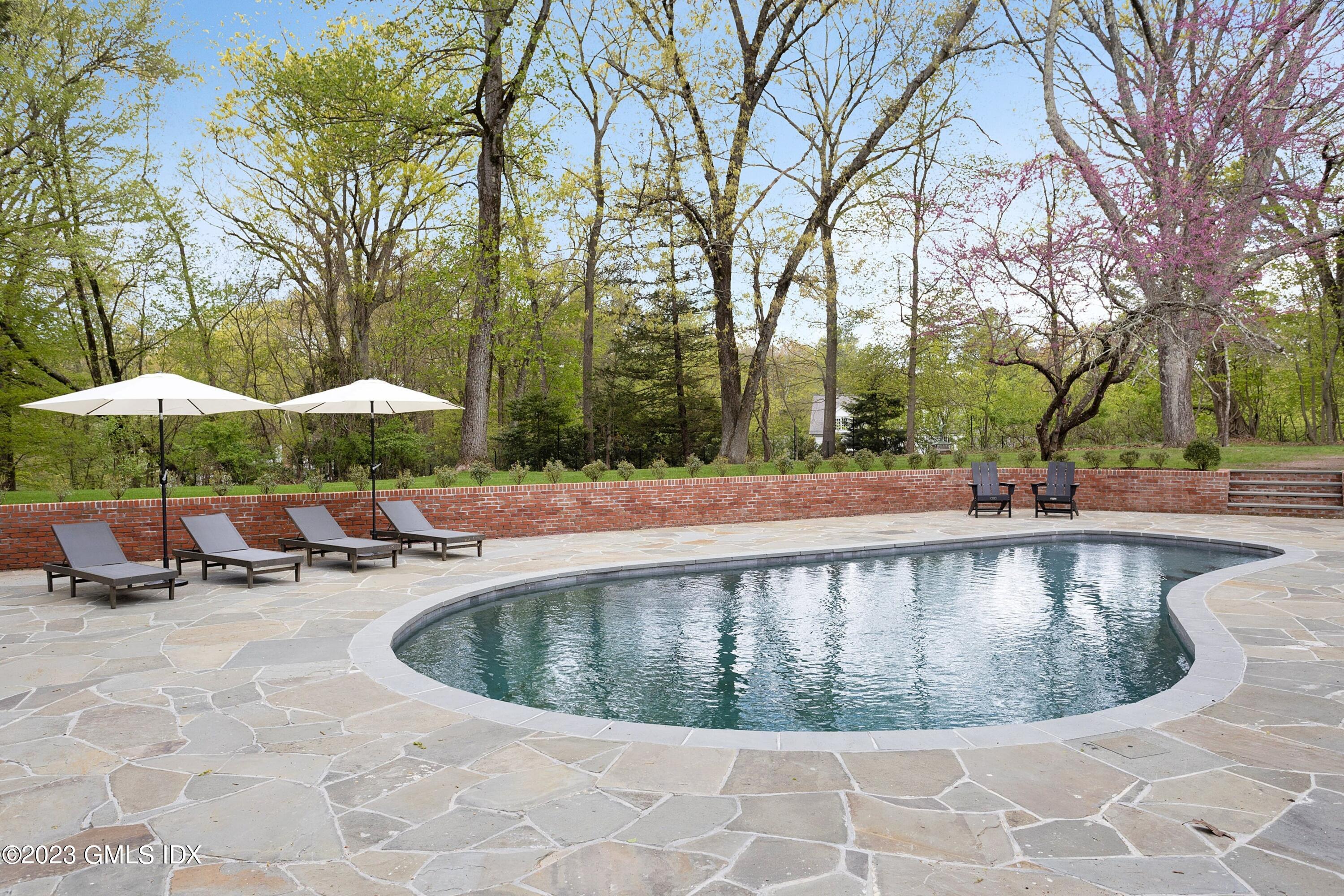 48 Old Mill Road Greenwich, CT 06831 - Photo 41 of 47 a view of a swimming pool with chairs