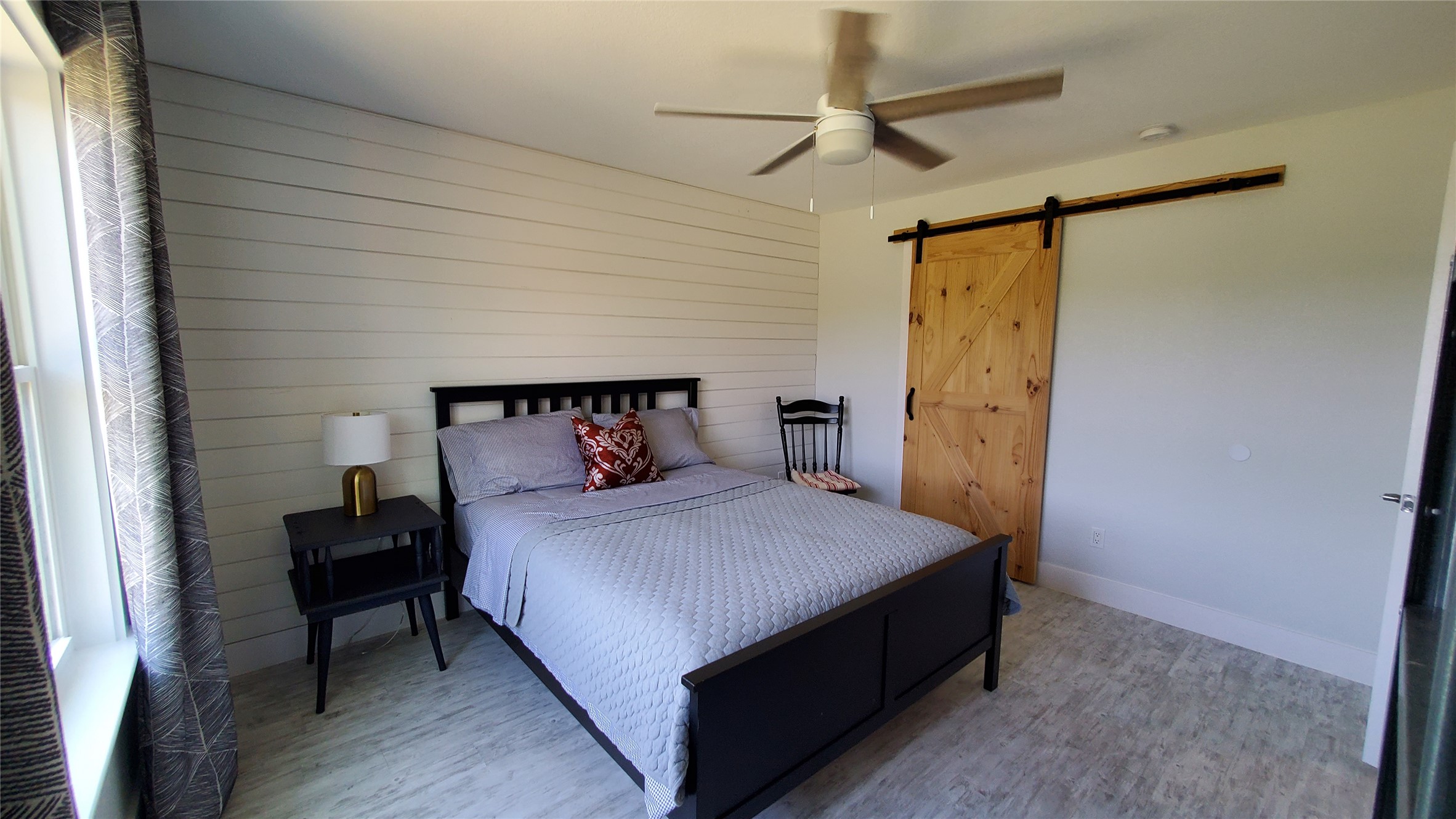 10201 Sandy Beach Road Dripping Springs, TX 78620 - Photo 6 of 13 a bedroom with a bed and a potted plant