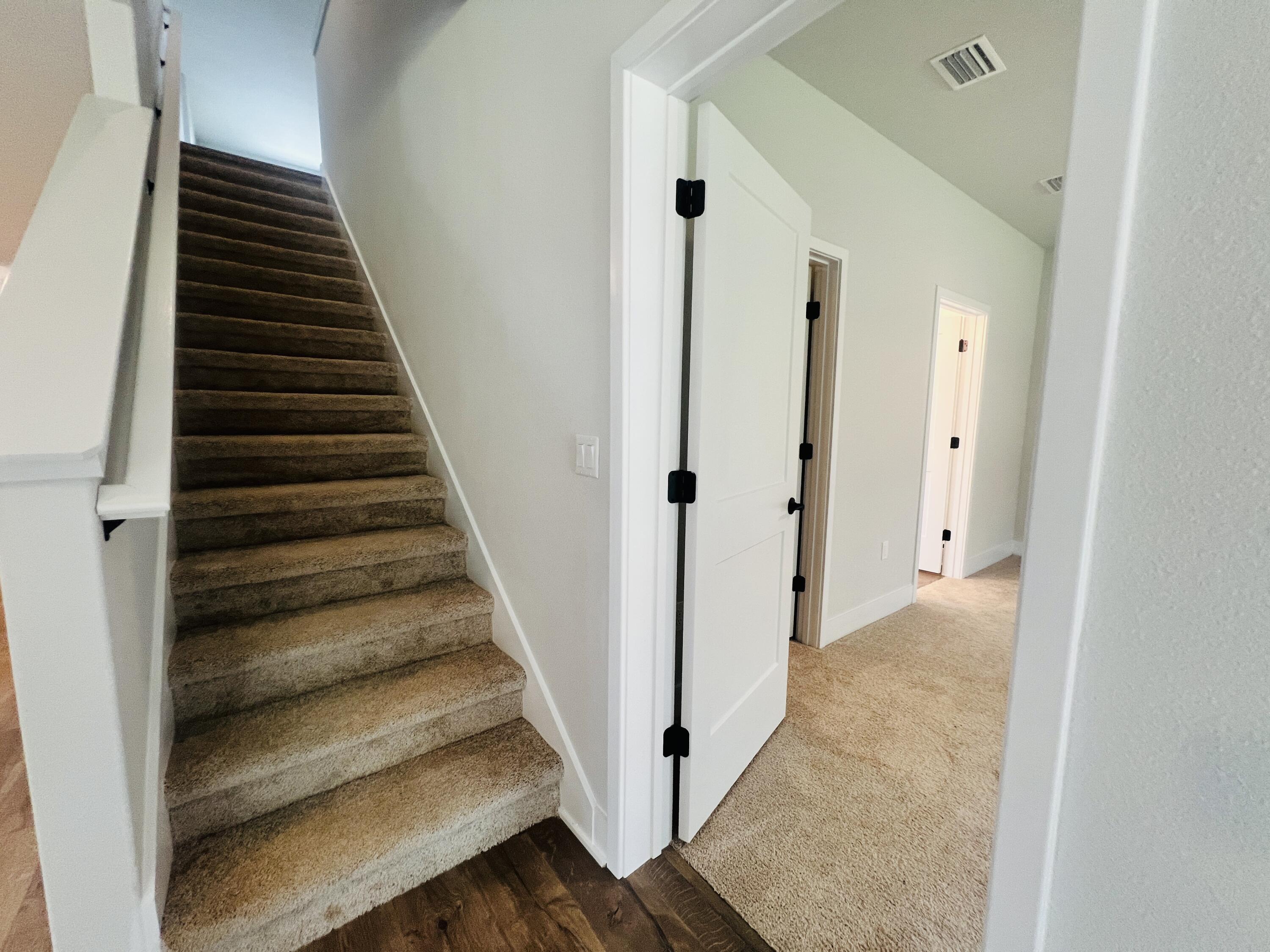 5299 Hidden Pines Circle Milton, FL 32583 - Photo 14 of 33 a view of a hallway with wooden floor and entryway