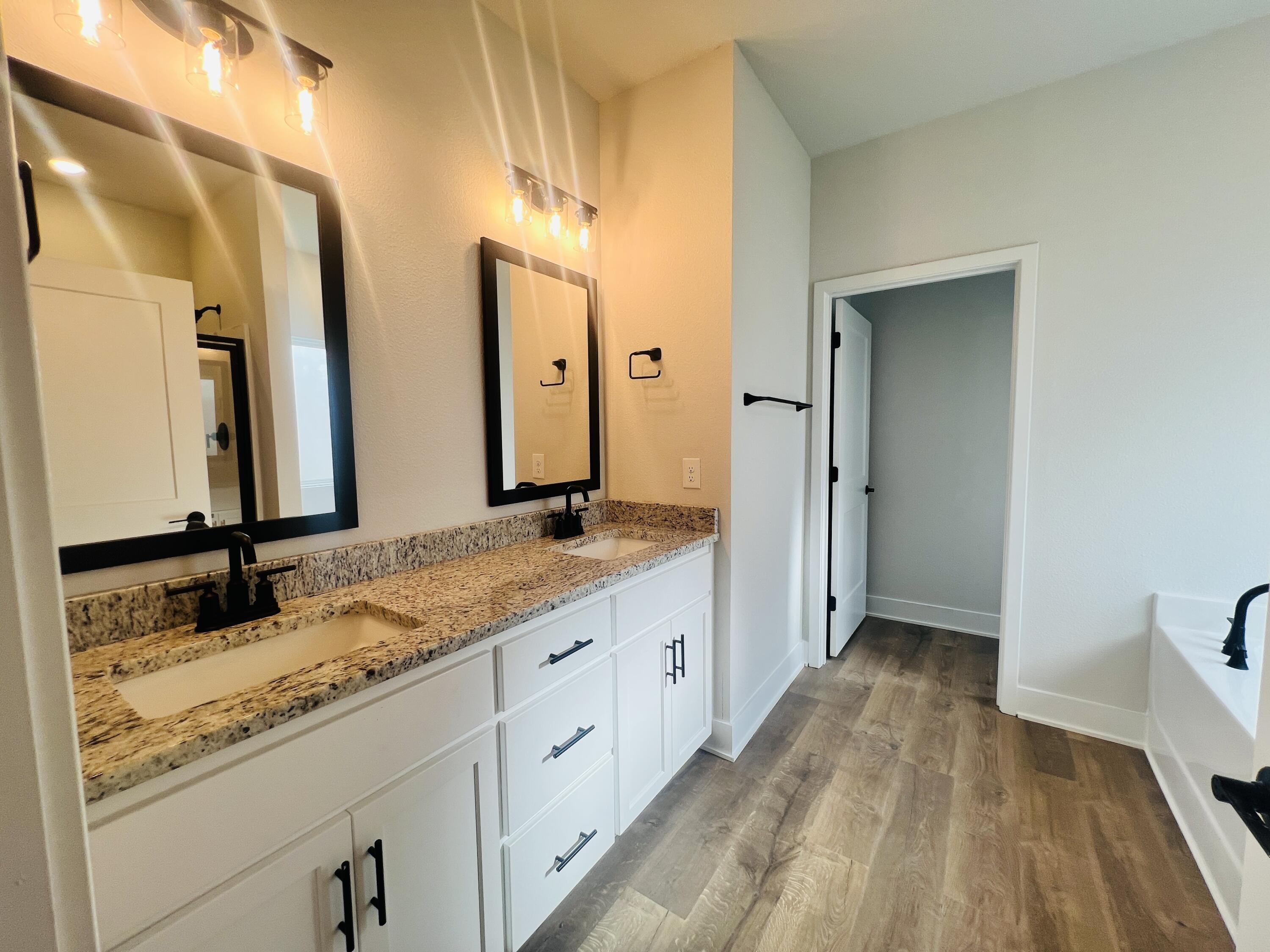 5299 Hidden Pines Circle Milton, FL 32583 - Photo 17 of 33 a spacious bathroom with a granite countertop sink mirror and a