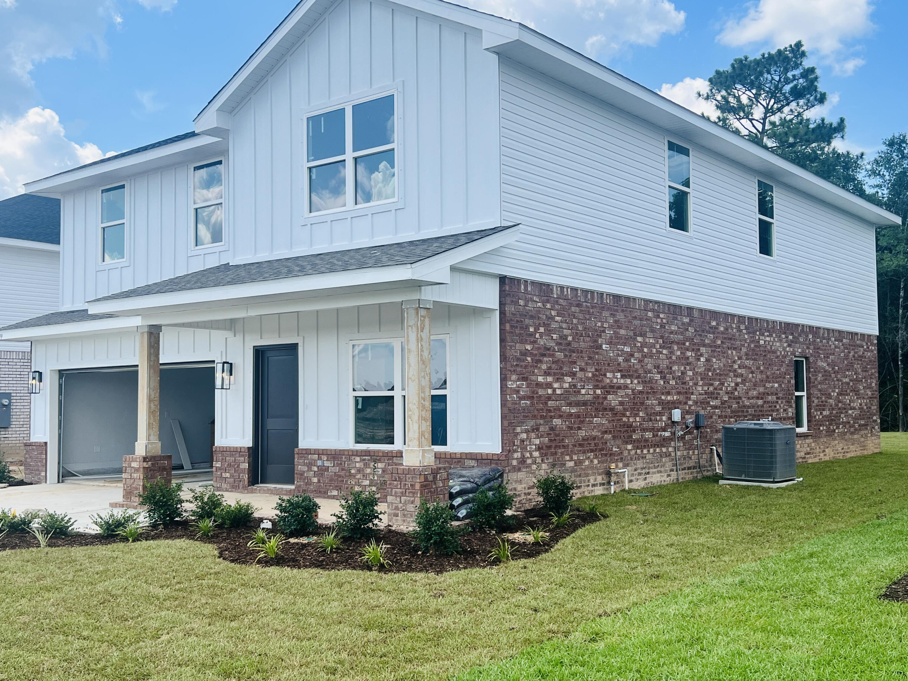 5299 Hidden Pines Circle Milton, FL 32583 - Photo 2 of 33 front view of a house with a yard