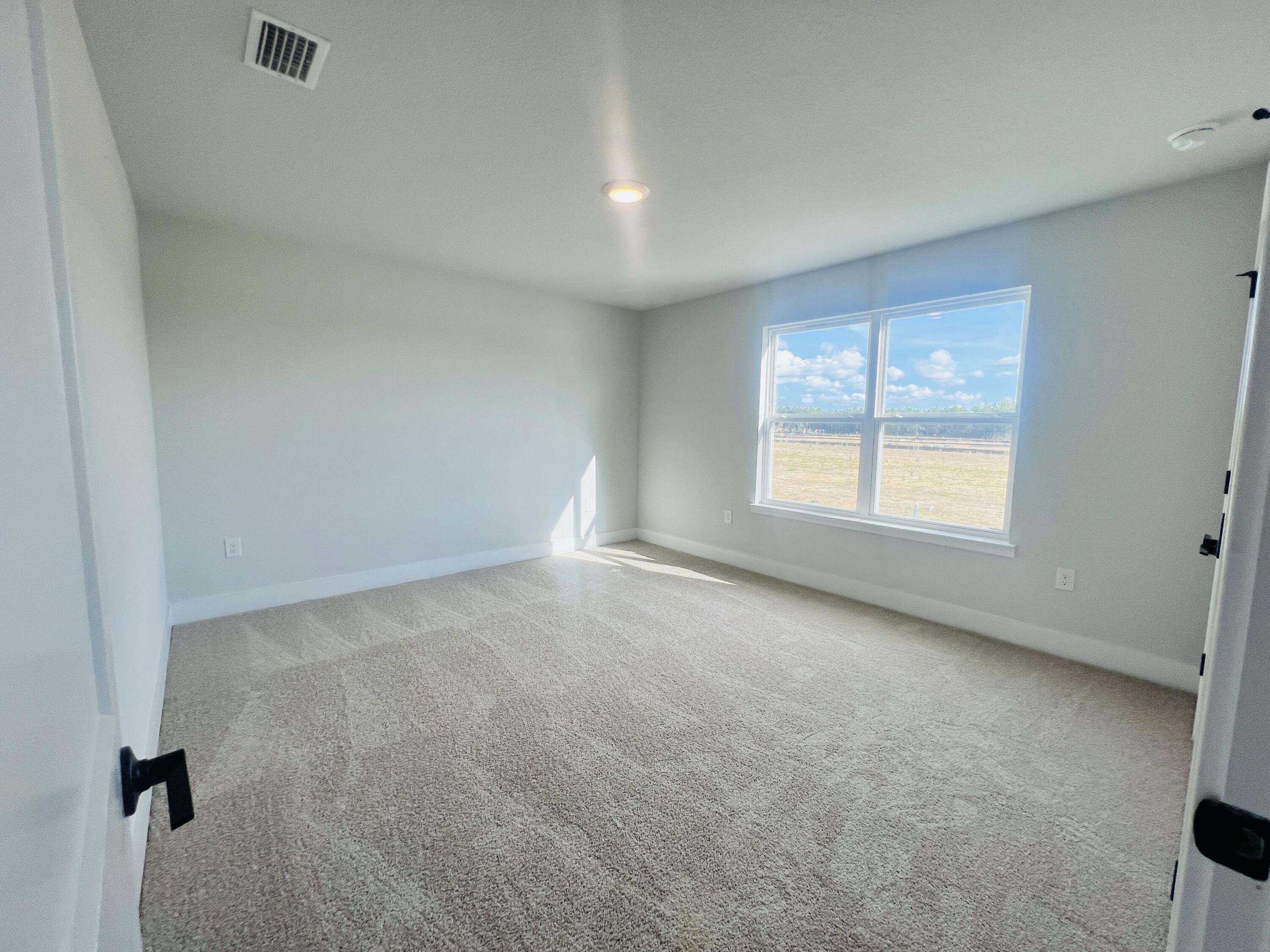 5299 Hidden Pines Circle Milton, FL 32583 - Photo 24 of 33 an empty room with windows