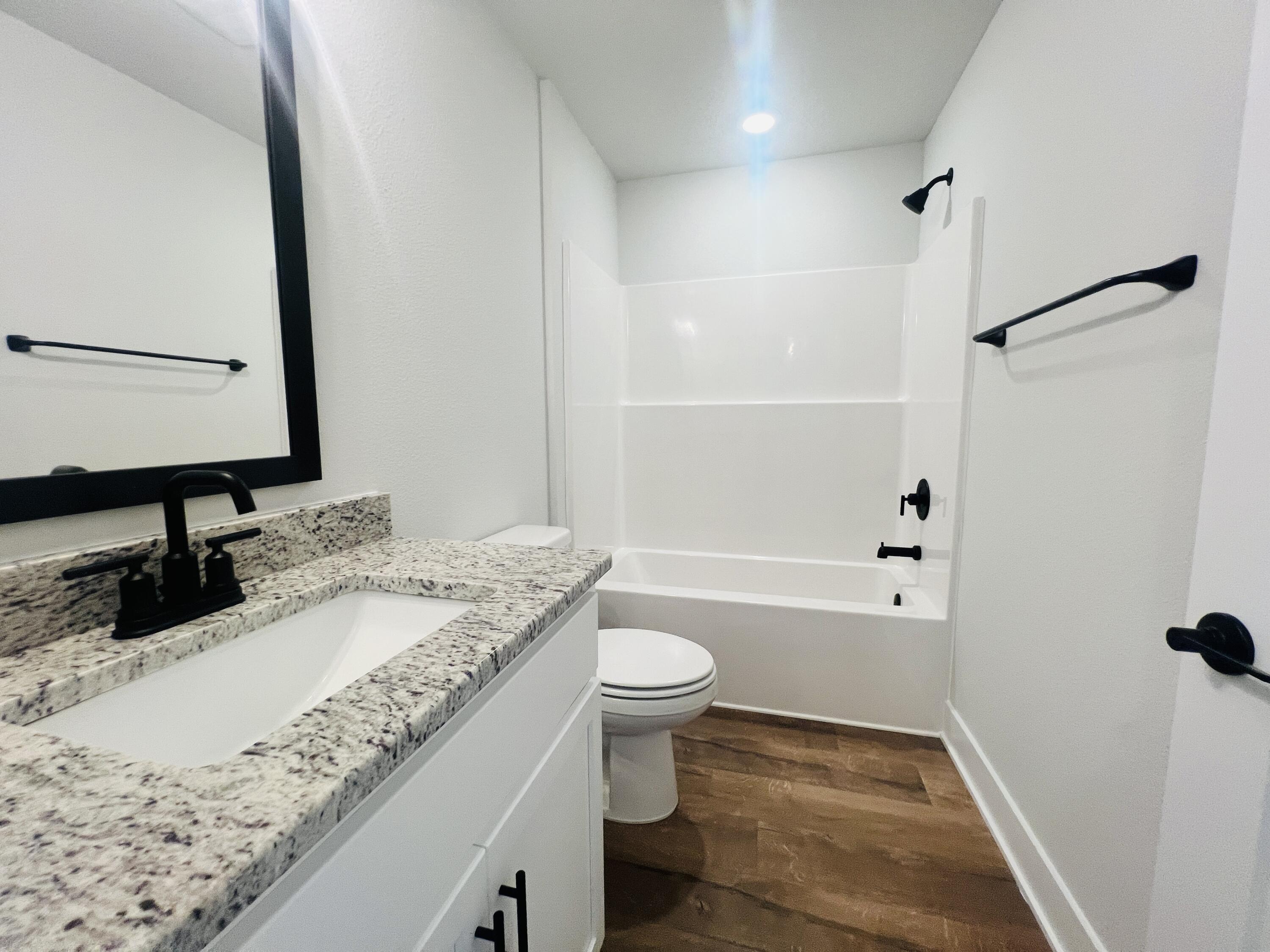 5299 Hidden Pines Circle Milton, FL 32583 - Photo 27 of 33 a bathroom with a granite countertop sink toilet and shower