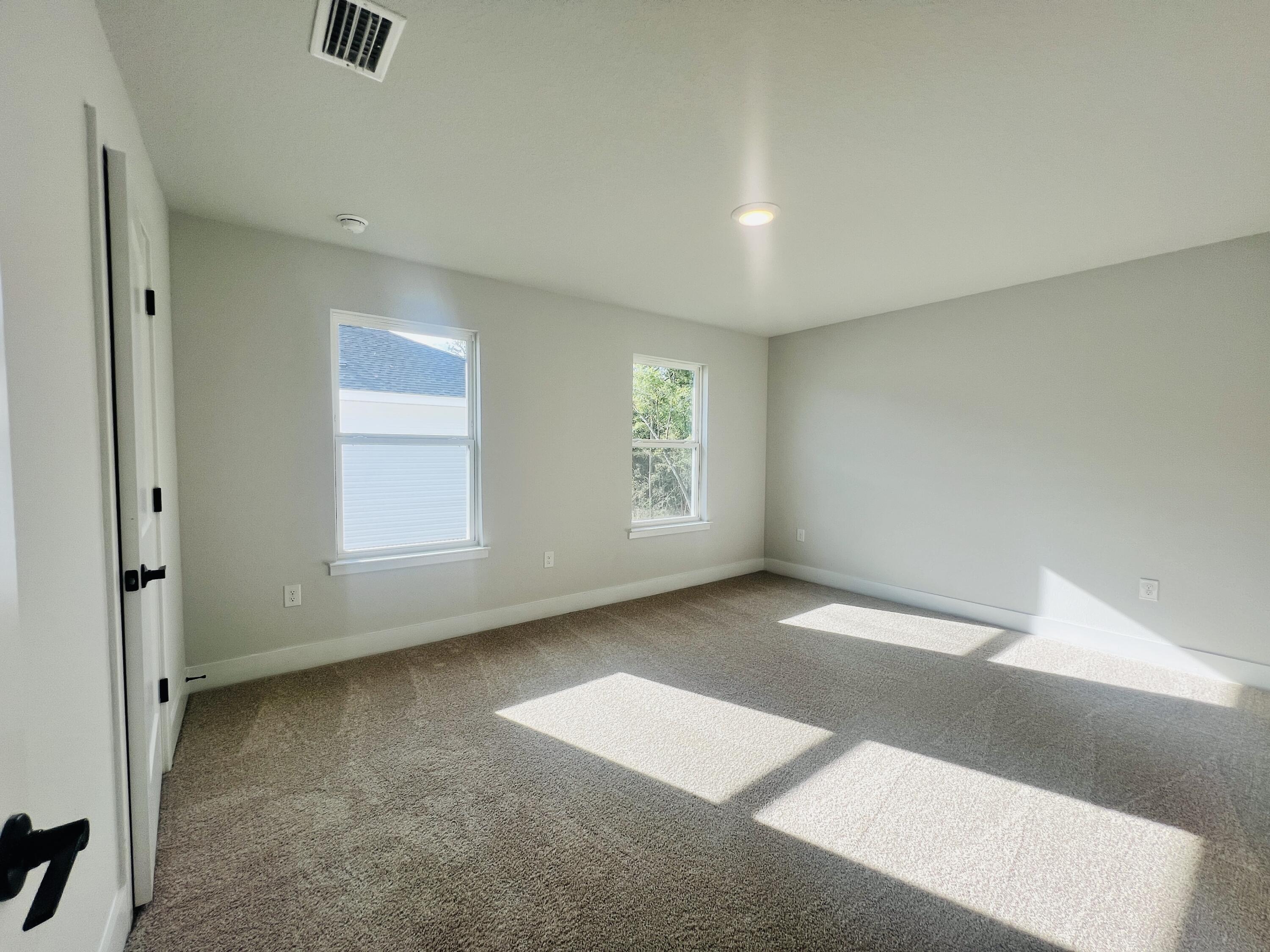 5299 Hidden Pines Circle Milton, FL 32583 - Photo 28 of 33 an empty room with windows