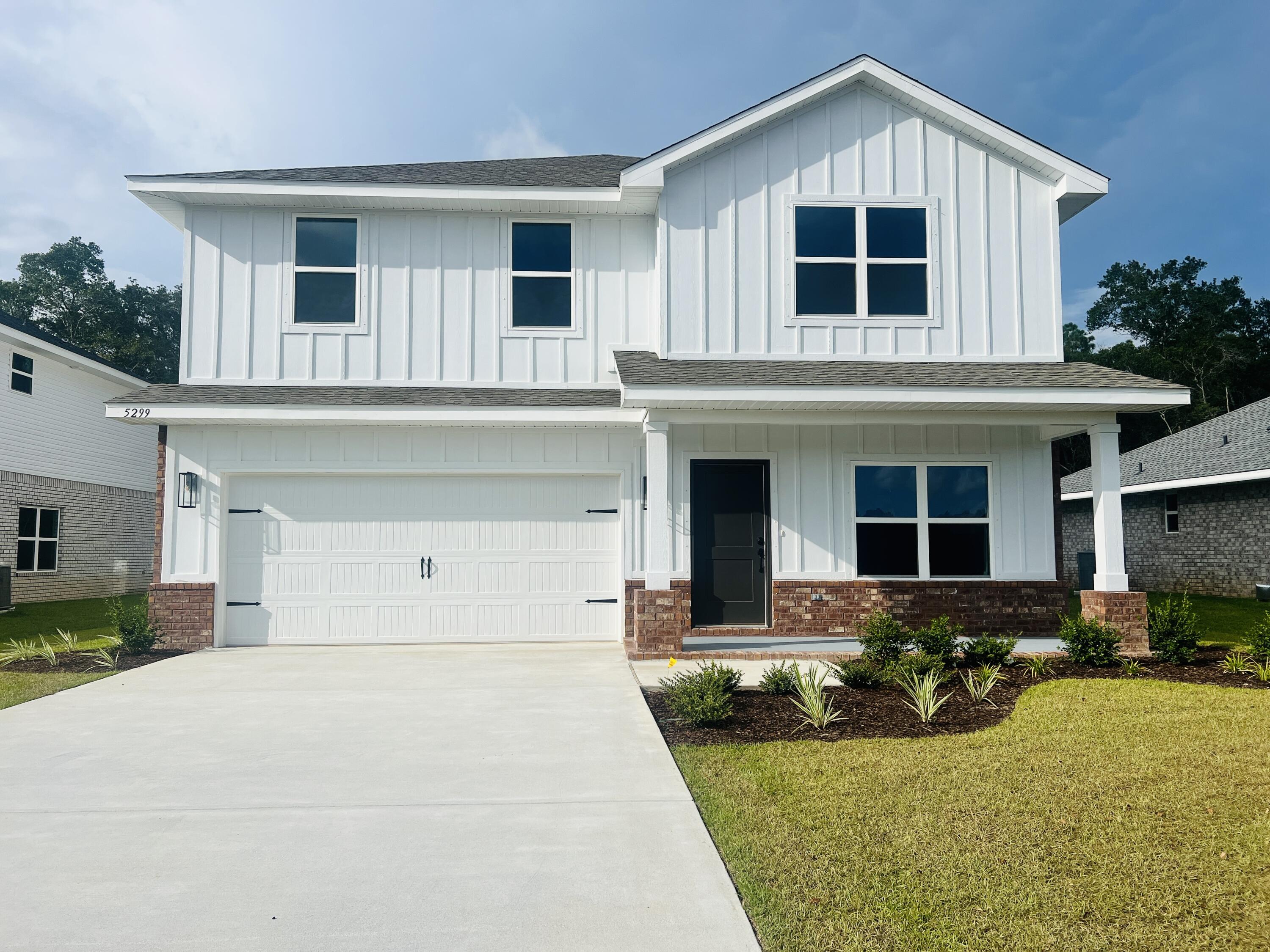 5299 Hidden Pines Circle Milton, FL 32583 - Photo 3 of 33 front view of a house with a yard