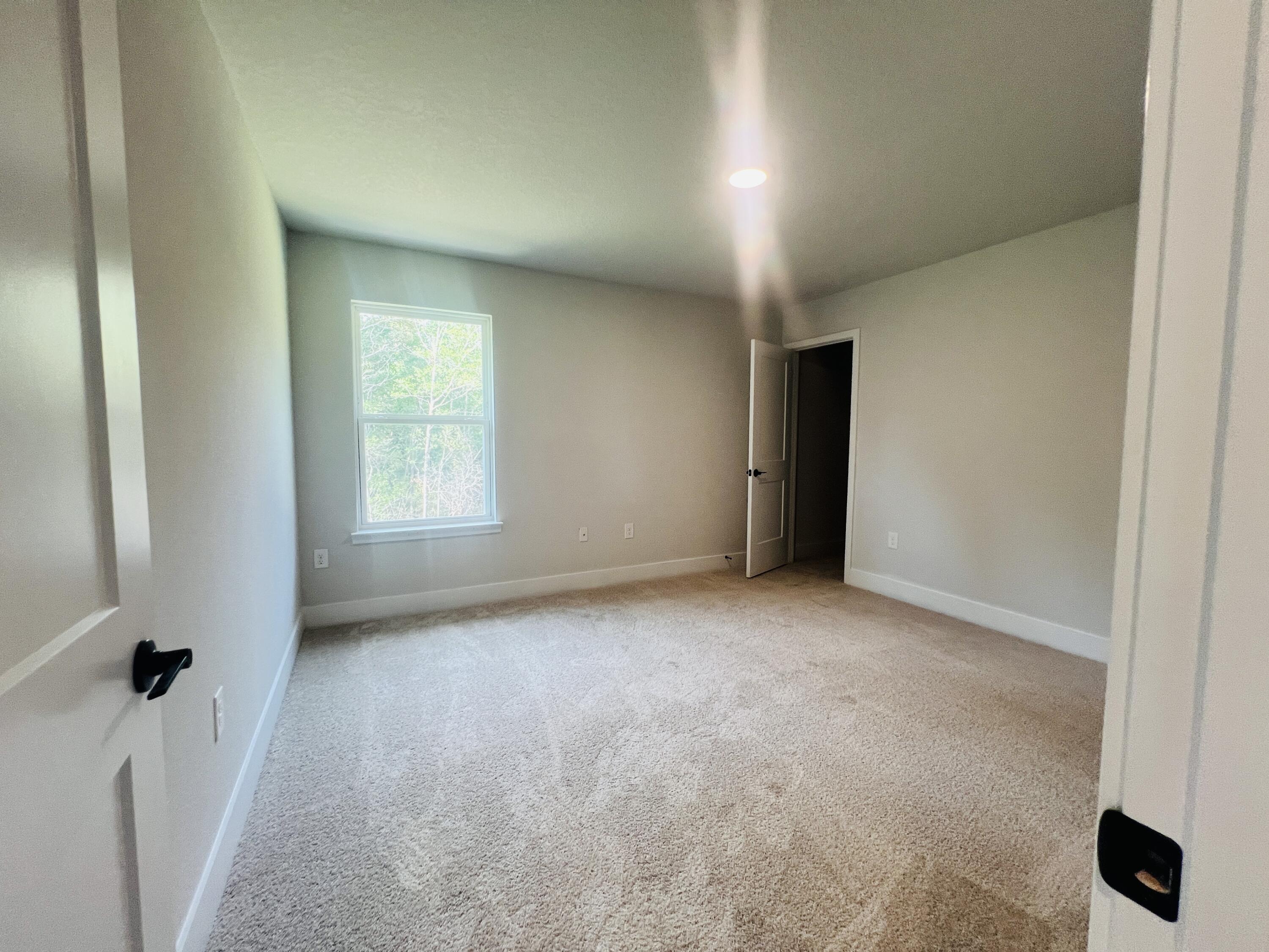 5299 Hidden Pines Circle Milton, FL 32583 - Photo 31 of 33 an empty room with a window