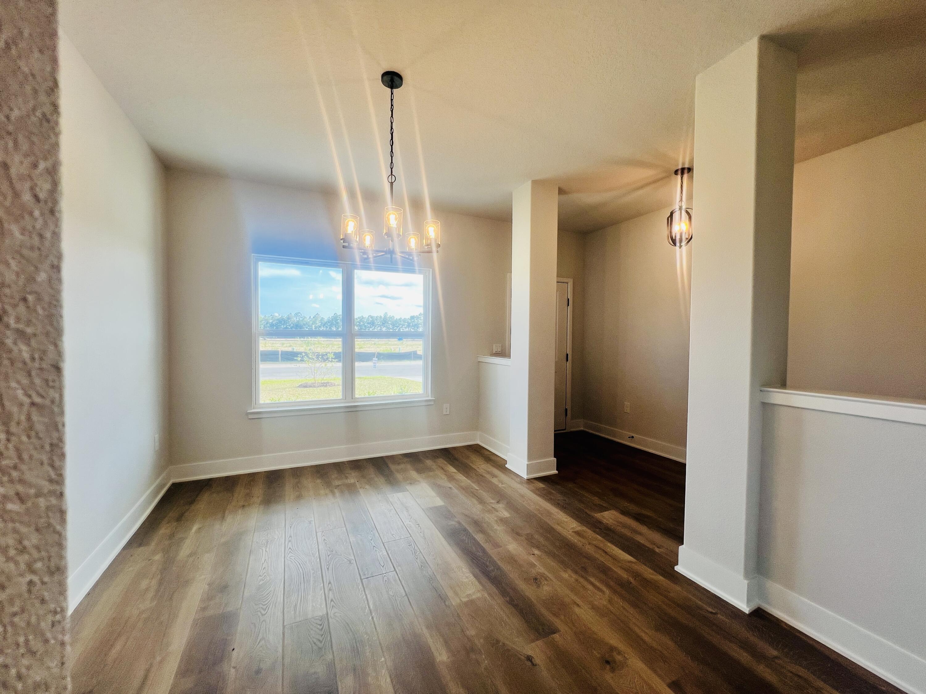5299 Hidden Pines Circle Milton, FL 32583 - Photo 8 of 33 a view of empty room with wooden floor and fan