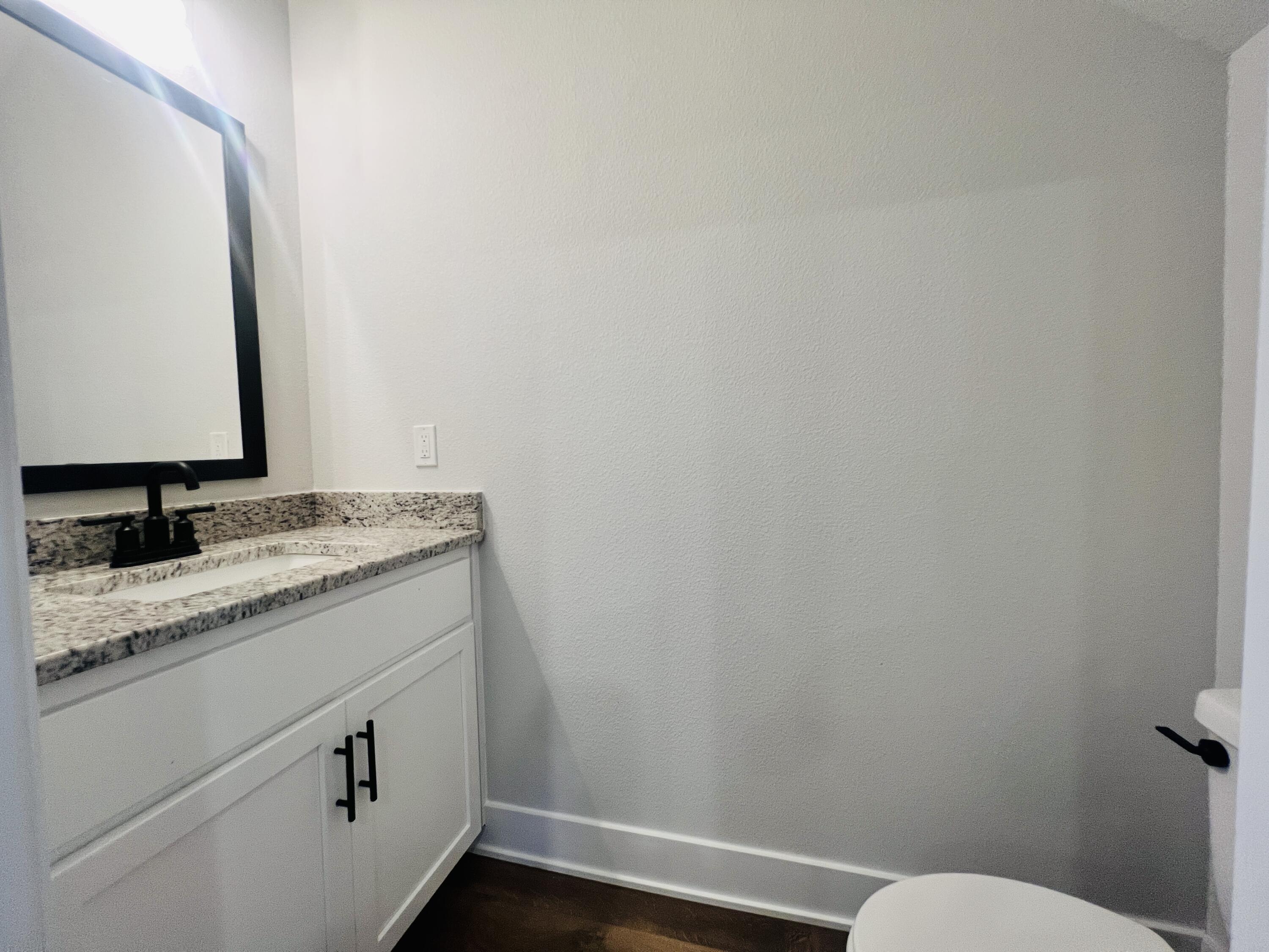 5299 Hidden Pines Circle Milton, FL 32583 - Photo 10 of 33 a bathroom with a granite countertop sink and a toilet