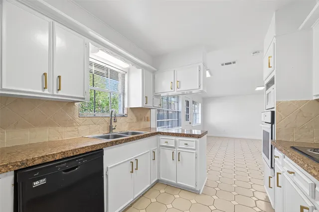 a kitchen with a sink stove and cabinets