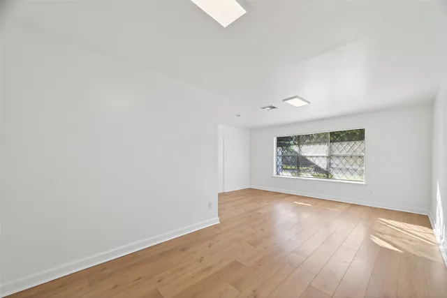 a view of a room with a window and a ceiling fan