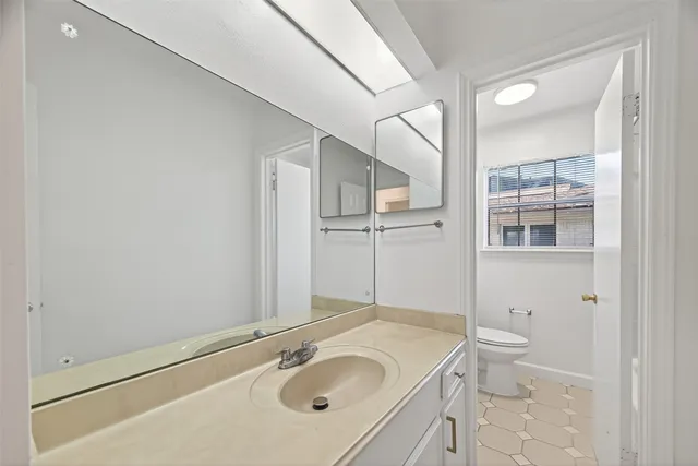 a view of a big room with wooden floor and windows