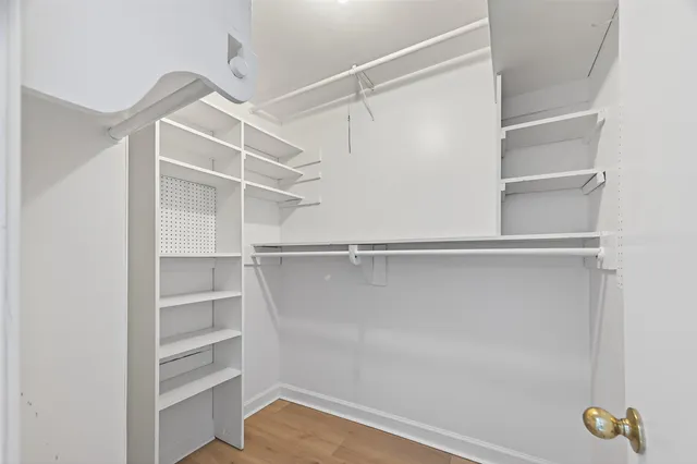 a bathroom with a granite countertop sink toilet a large mirror and shower