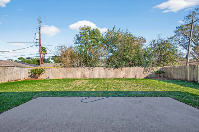 a view of a house with a backyard and a garden