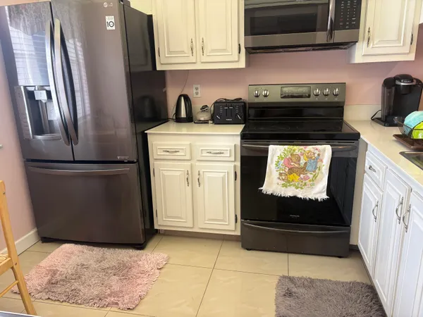 a kitchen with appliances and cabinets