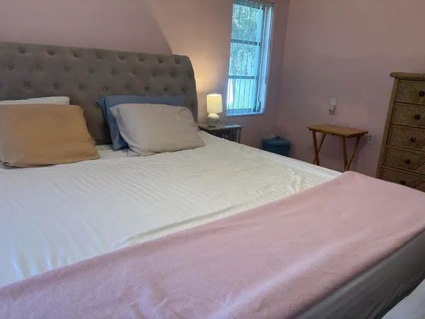 a bedroom with a bed and window