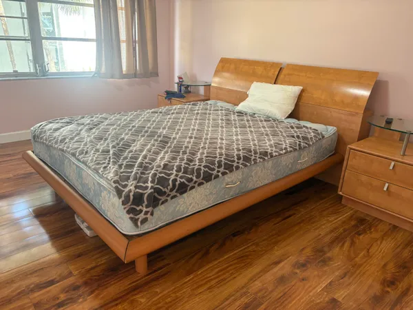 a bed sitting in a bedroom next to a window