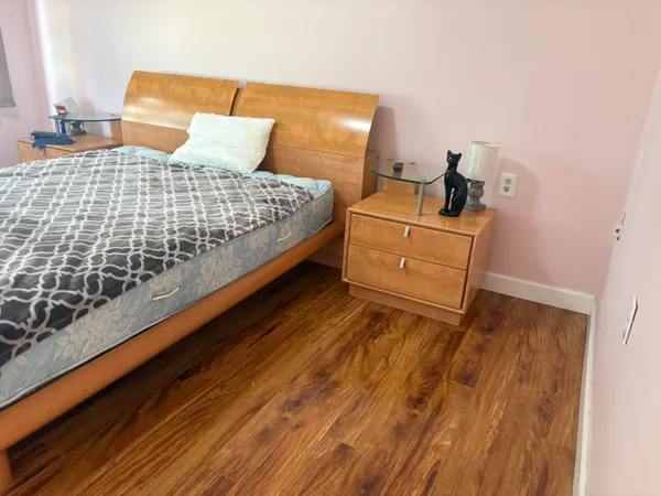 a bedroom with a bed and dresser