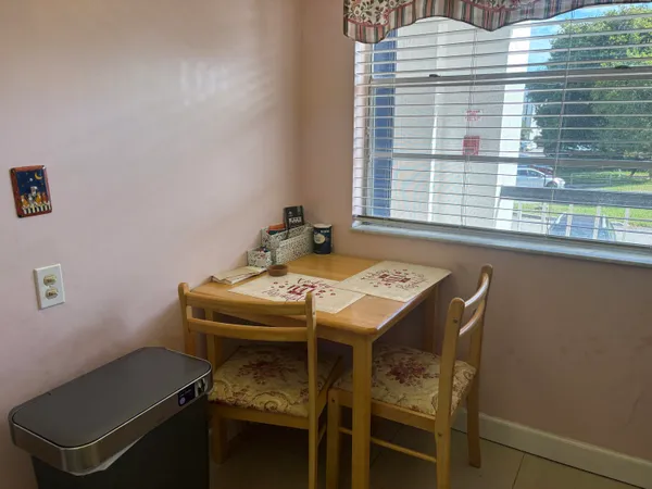 a dining room with furniture and window