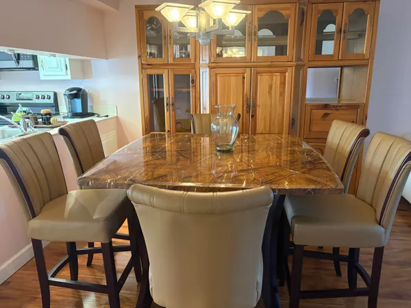 a view of a dining room with furniture large window and wooden floor