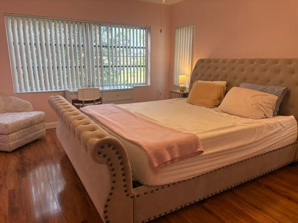 a bedroom with a bed and a couch