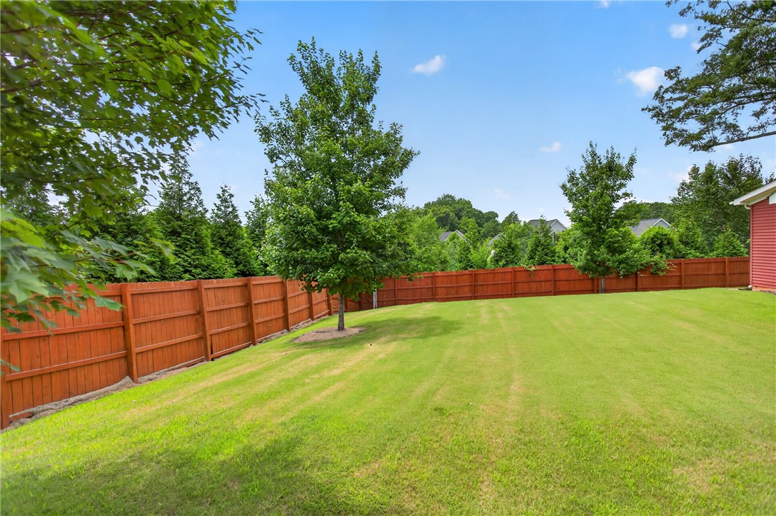 235 Pendleton Road, Unit K1 Clemson, SC 29631 - Photo 8 of 49 A vast, emerald-green lawn, fully enclosed by a sturdy privacy fence, awaits outdoor enjoyment.