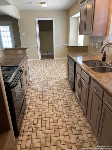 a kitchen with a sink and a stove