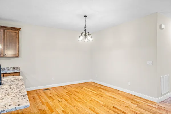 a view of a livingroom with wooden floor and a ceiling fan