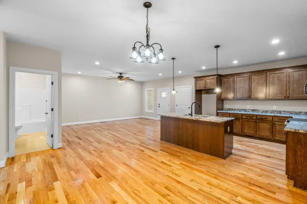 a large kitchen with kitchen island a sink stainless steel appliances and cabinets