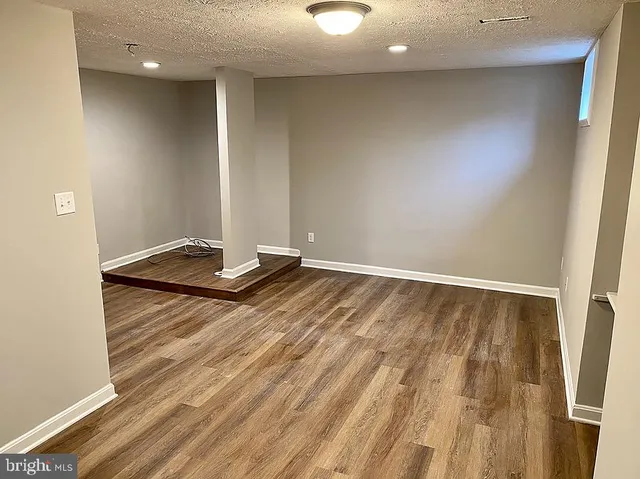 a view of room with wooden floor