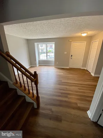 a view of entryway with stairs and wooden floor