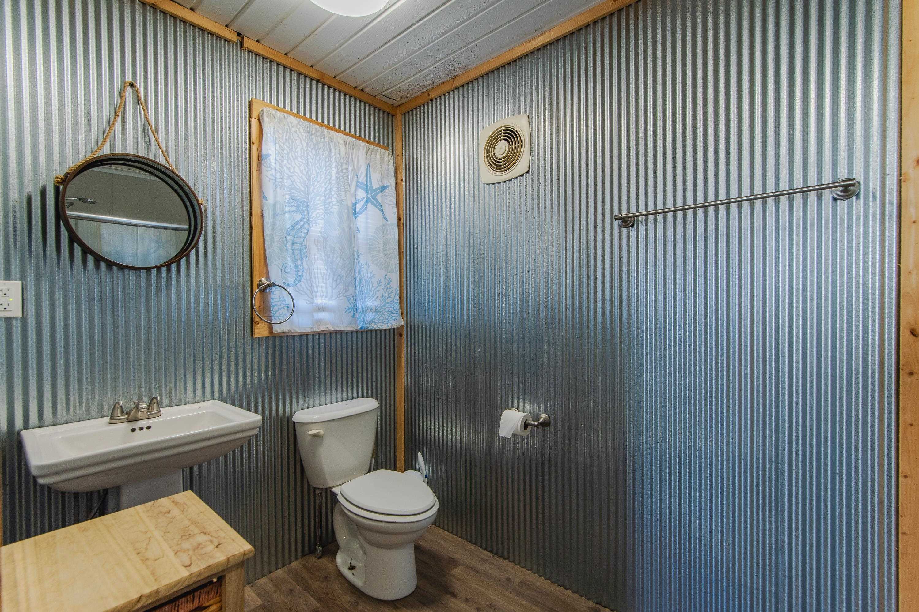 1111 Leaning Trees Lane Adamsville, TN 38310 - Photo 24 of 36 Bathroom featuring wood ceiling, sink, wood-type flooring, and toilet