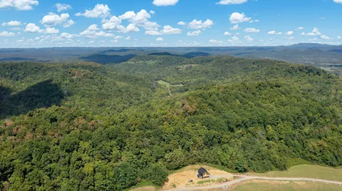 a view of a big yard with lots of green space
