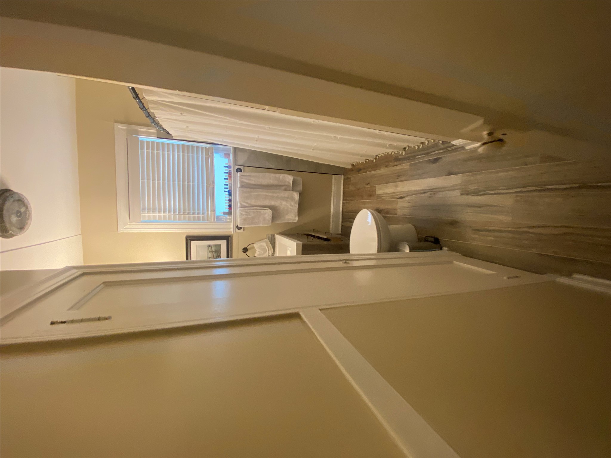 3010 Fruth Street, Unit A Austin, TX 78705 - Photo 28 of 39 Bathroom featuring wood-finish flooring, a white vanity with a rectangular sink, a toilet, and a shower area with a white curtain