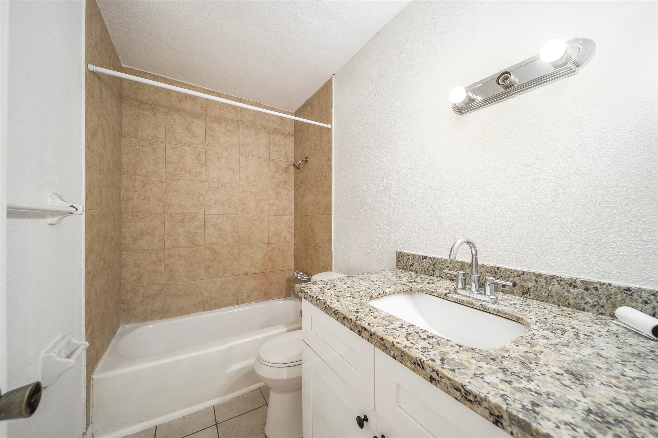 6201 Ranchester Drive, Unit 36 Houston, TX 77036 - Photo 16 of 23 a bathroom with a granite countertop sink a toilet and shower