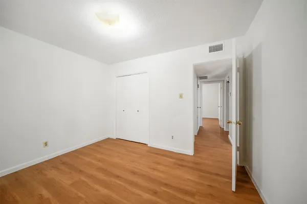 a view of a room with wooden floor and bench