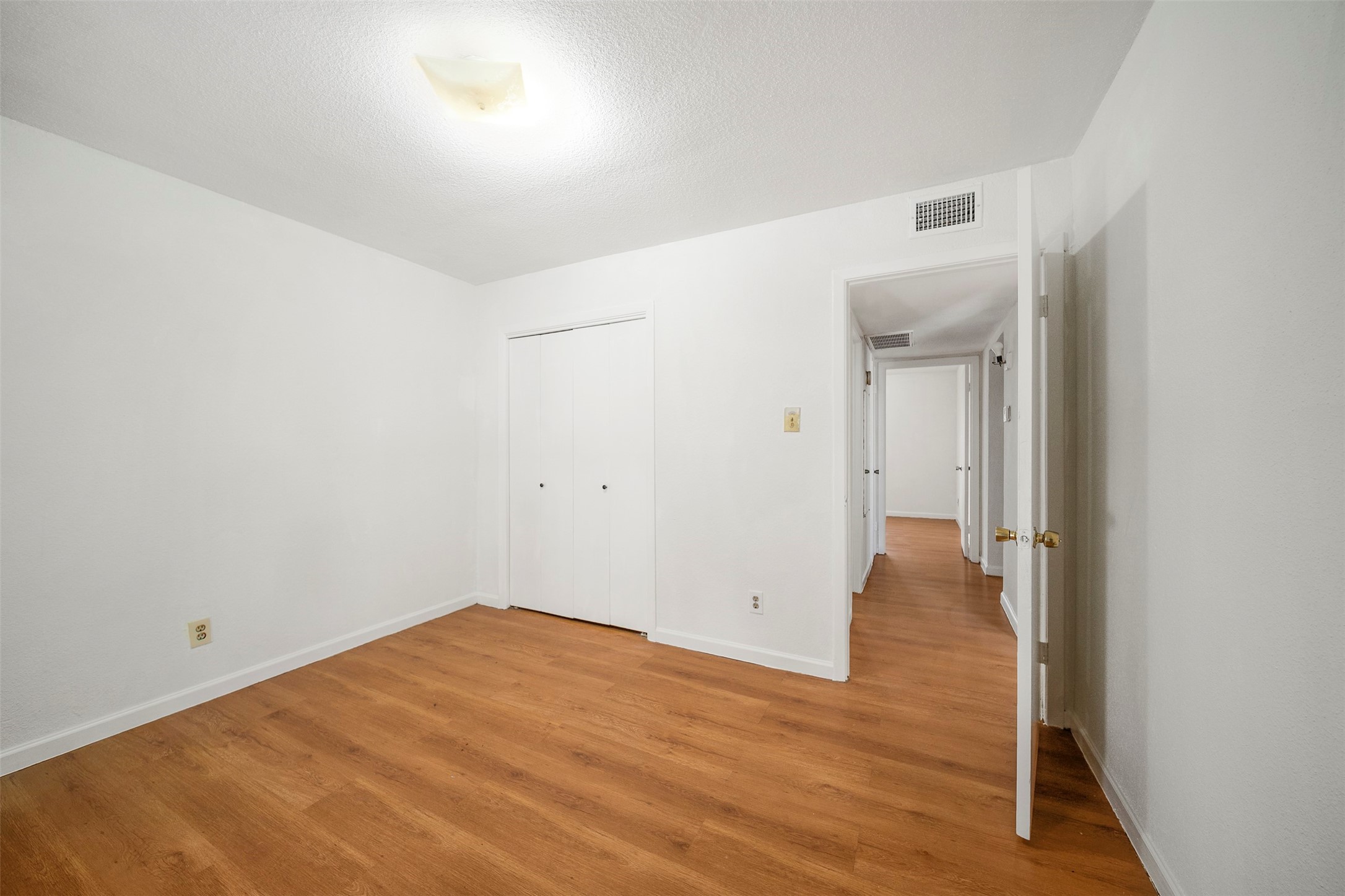 6201 Ranchester Drive, Unit 36 Houston, TX 77036 - Photo 18 of 23 a view of a room with wooden floor and bench