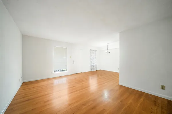a view of an empty room and wooden floor