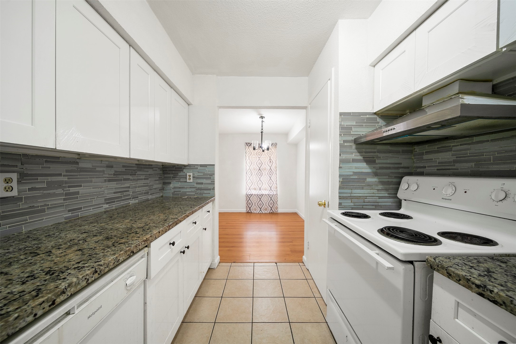 6201 Ranchester Drive, Unit 36 Houston, TX 77036 - Photo 10 of 23 a kitchen with granite countertop a sink a stove and cabinets