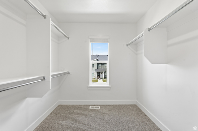 1173 West 1870 South Logan, UT 84321 - Photo 13 of 33 Walk-in closet featuring light grey carpet, white walls, and built-in closet organization with shelving and hanging rods