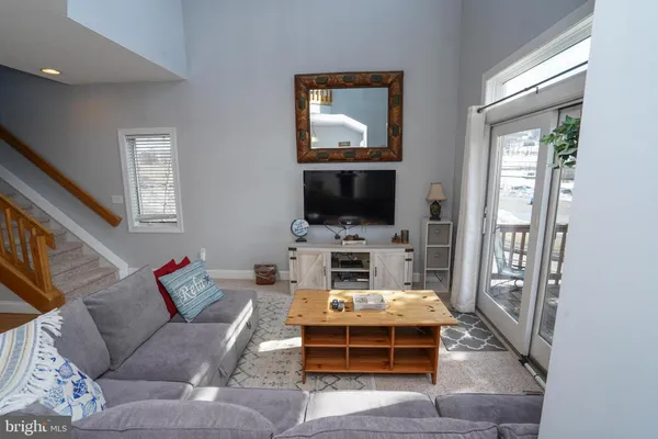a kitchen that has a sink and chairs in it