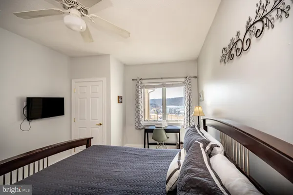 a living room with furniture a window and a flat screen tv