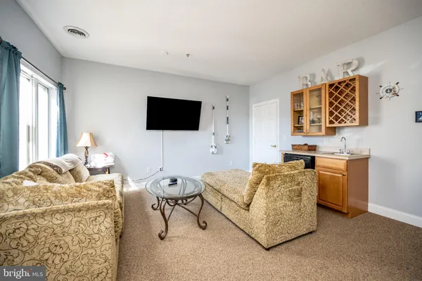 a living room with furniture fireplace and flat screen tv