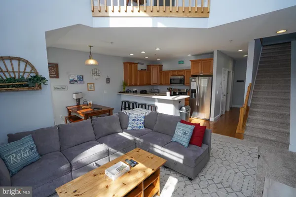 a living room with furniture a flat screen tv and a window