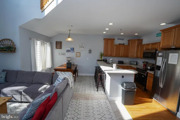 a kitchen with stainless steel appliances a table and chairs