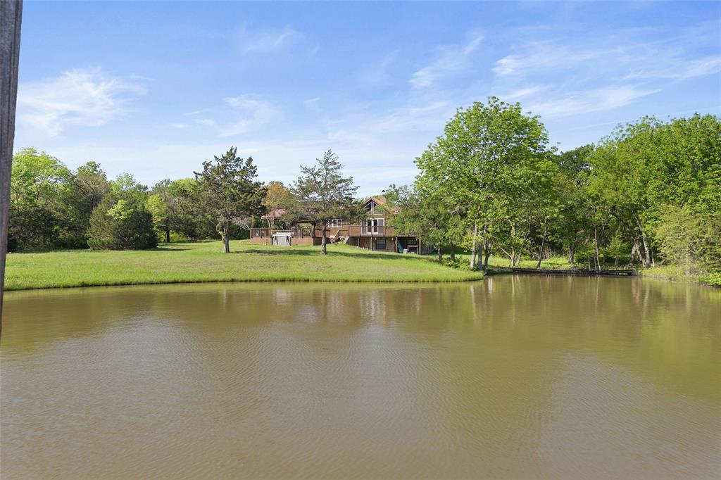 821 Ewing Road Ferris, TX 75125 - Photo 23 of 40 a view of a lake with houses in the background